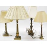 Four various gilt brass and wood finish table lamps, each on Corinthian column supports, with pad fe