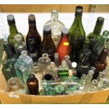A group of various glass bottles, some marked, mainly clear glass, green glass and brown bottles. (1