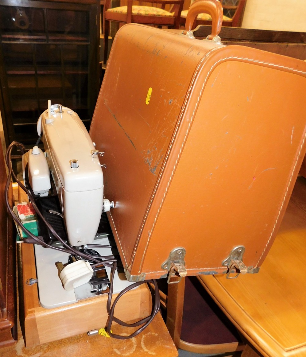 A Singer electric sewing machine, cased.