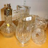 A group of glassware, to include a silver plated rimmed claret jug and various other glass jugs. (a