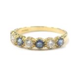 An 18ct gold sapphire and diamond dress ring, set with four round brilliant cut sapphires, each appr