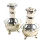 A pair of George V silver pepperettes, each of baluster form raised on three feet, Birmingham 1921,