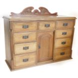 A late Victorian walnut dresser, with a raised back above a moulded edge and an arrangement of nine