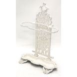 A Victorian style cast iron umbrella stand, with three apertures decorated with leaves, scrolls, etc