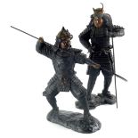 A pair of Japanese cast metal figures of Samurai, the first in crouched position holding spear, the
