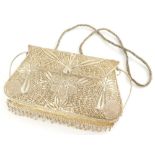 A mid 20thC wirework and pierced evening purse, of shaped form with floral and pierced body and stri