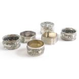 A collection of silver and silver plated napkin rings, to include a pair of silver napkin rings prof