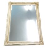 A cream painted wall mirror with bevel plate, 106cm high, 76cm wide.