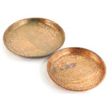A graduated pair of crocodile skin design copper Art Deco trays, each of circular form, the smaller