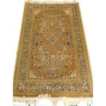 A Persian type mercerised cotton rug, with a central medallion, surrounded by an all over pattern of