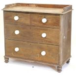 A Victorian pine chest of drawers, with a raised gallery above two short and two long drawers, each