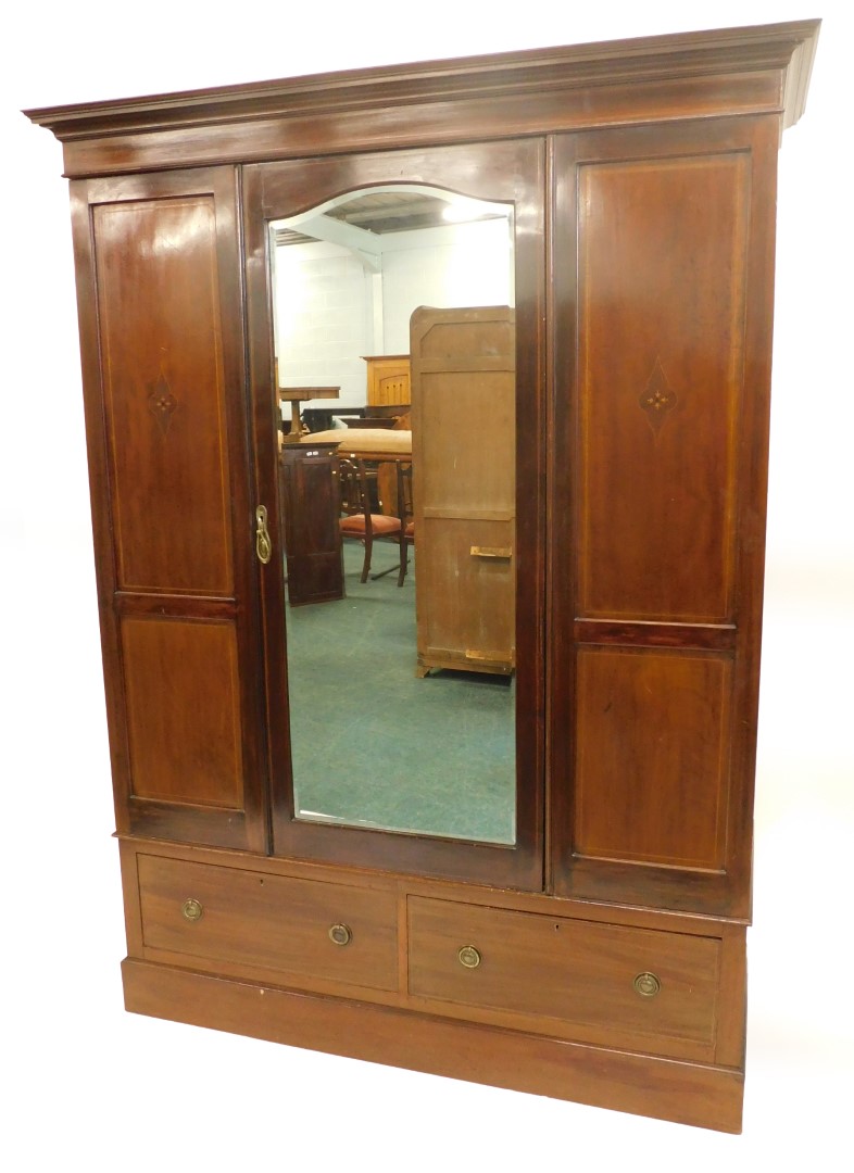 An Edwardian mahogany and inlaid wardrobe, the central mirror door, above two drawers, 206cm high, 1