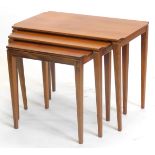 A nest of three G-plan type teak tables, each with a rectangular top on square tapering legs, the la