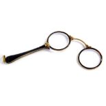 An early 20thC tortoiseshell and gold coloured metal lorgnette, each with a tapering handle cast wit