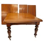 A Victorian mahogany extending dining table, the rectangular top with a moulded edge on turned taper