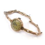 A 9ct gold cased ladies wristwatch, the small circular gold coloured dial with blue hands in a 9ct g