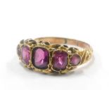 A yellow metal dress ring, set with five facet cut amethyst, unmarked.
