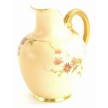 A Royal Worcester porcelain ewer or jug, painted with flowers on a blush ivory ground, printed marks