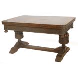 An early to mid 20thC oak draw leaf refectory table, the rectangular top with rounded corners above