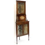 An Edwardian mahogany and satinwood crossbanded standing corner cabinet, the top with a glazed door