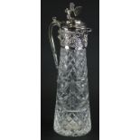 A 20thC silver plated and cut glass claret jug, with a lion and shield finial, floral scroll handle