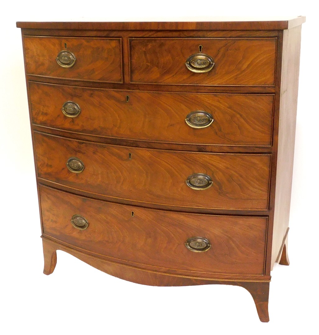 A Victorian mahogany bowfronted chest of drawers, with two short, three long drawers, each with oval