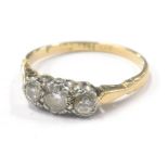 A diamond three stone dress ring, with three illusion set round brilliant cut diamonds, approx 0.15c