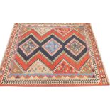 A Kilim rug, with a geometric design in cream, blue, navy, etc., 182cm x 229cm.