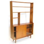 A 1960s/70s teak display unit, with various shelves, glass and a sliding door on turned legs, 167cm