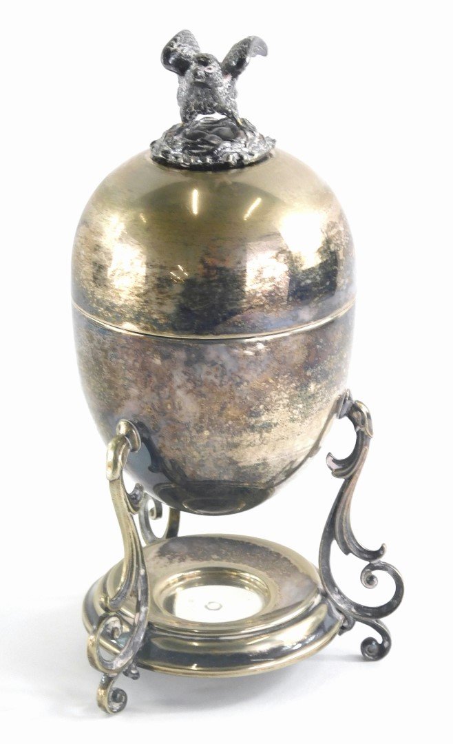 A Victorian silver plated egg coddler or egg holder, the finial cast as a bird seated on a nest, (AF