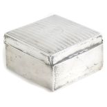 An early 20thC silver cigarette box, of square form with monogrammed cartouche C.S. and vertical lin