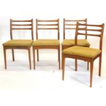 A set of four 1960s/70s teak ladder back dining chairs, each with a padded seat on square tapering l