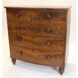 A Victorian mahogany bow fronted chest of drawers, with two short and three long drawers, each with