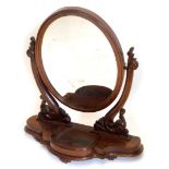 A Victorian mahogany dressing table mirror, the over plate on pierced carved supports, with shaped b