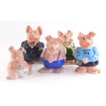 A group of Wade NatWest pigs, to include two males, two females and a baby together with