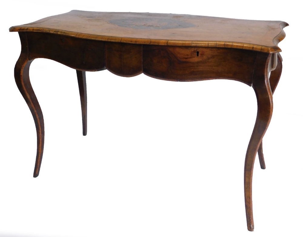 A 19thC walnut library table in French style, the shaped rectangular top with a central marquetry ca