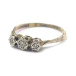 A three stone diamond ring, with illusion setting in 18ct gold, 1.7g all in.