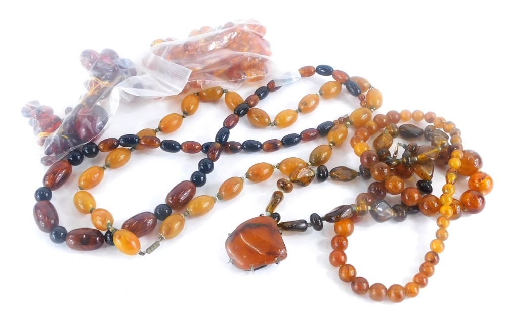 A group of imitation amber jewellery, beaded necklaces, brooches, etc. (1 bag)