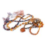 A group of imitation amber jewellery, beaded necklaces, brooches, etc. (1 bag)