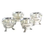 A set of four George V silver salts, by Wakely and Wheeler, with a shaped rim and decorative banding