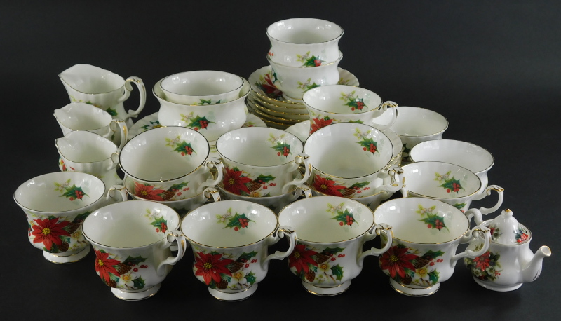 A Royal Albert Poinsettia part service, to include tea cups, miniature teapot, 7cm high, side plates