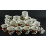 A Royal Albert Poinsettia part service, to include tea cups, miniature teapot, 7cm high, side plates