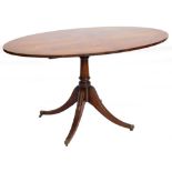 A mahogany breakfast table, the oval quarter veneered top with a crossbanded border on a turned colu