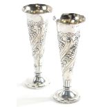 A pair of Victorian silver bud vases, the bodies heavily decorated with bows, flowers, leaves, etc,