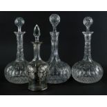 A set of three early 20thC cut glass decanters, each with orb stoppers and bulbous bodies, and anoth