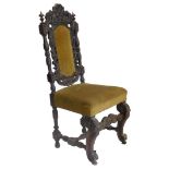 A Victorian ebonised oak side chair, with a padded back and seat on scroll carved legs. (AF)