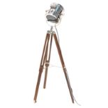 A hardwood and chrome floor lamp, modelled in the form of a cinema lamp.
