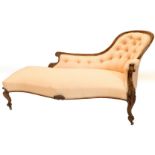A Victorian rosewood showframe chaise lounge, upholstered in coloured fabric on scroll carved legs,