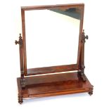 A Victorian figured mahogany dressing table mirror, rectangular shaped on shaped supports, with plat