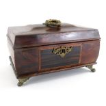 A regency style mahogany casket, of sarcophagus form with circular metal handle and plain interior,